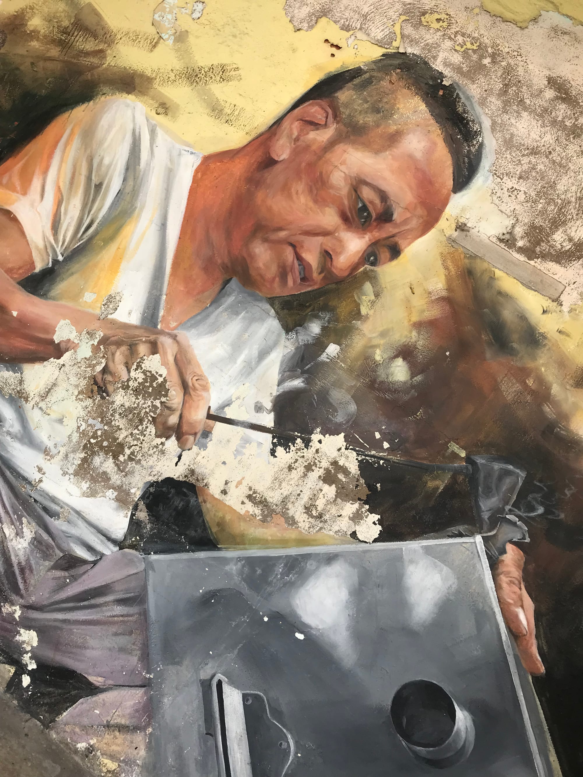 A mural of a middle-aged Chinese man working on a tin contraption