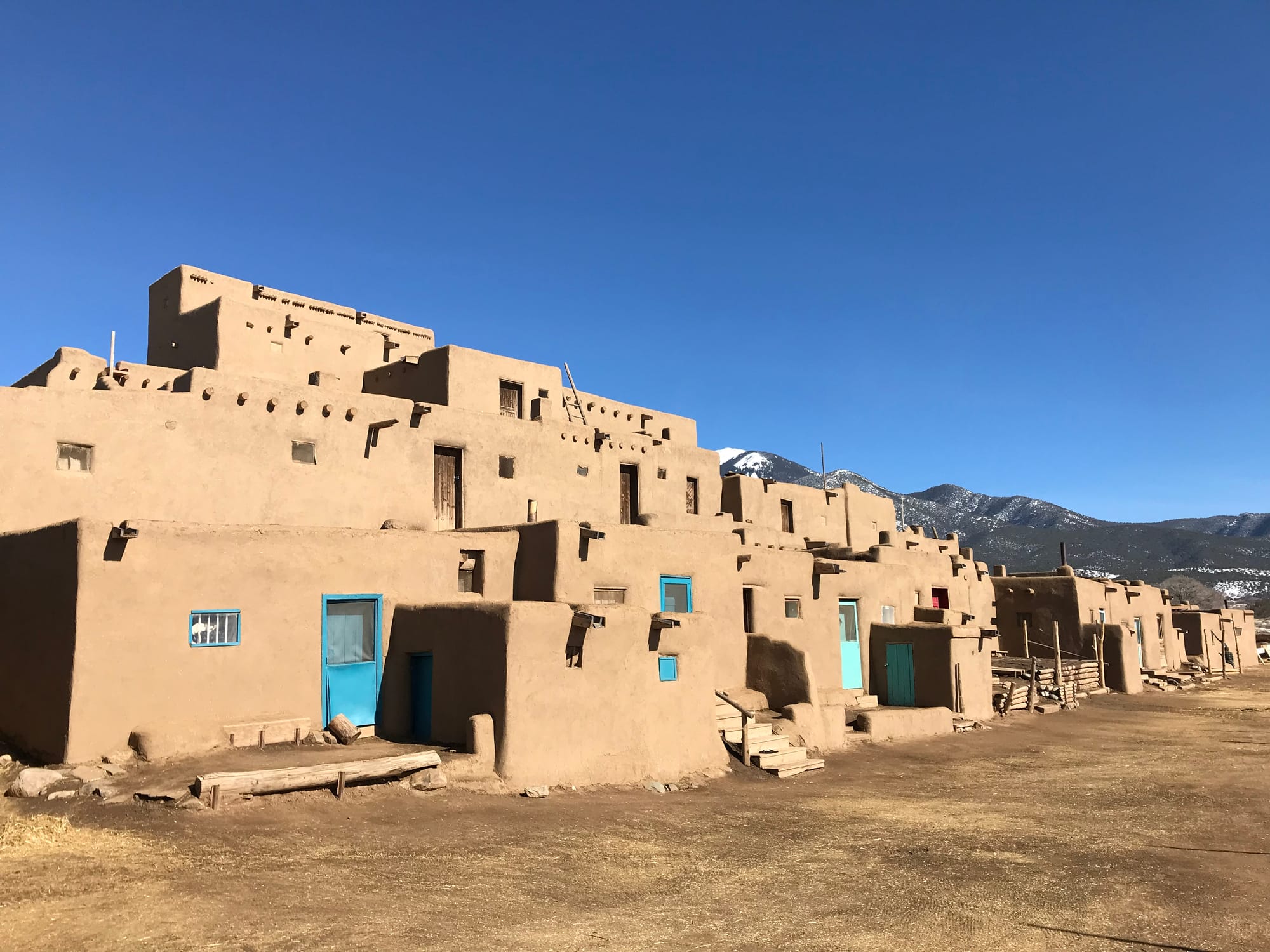 The north houses at Taos Pueblo with the image of George Washington on Taos Mountain peeking over the houses..